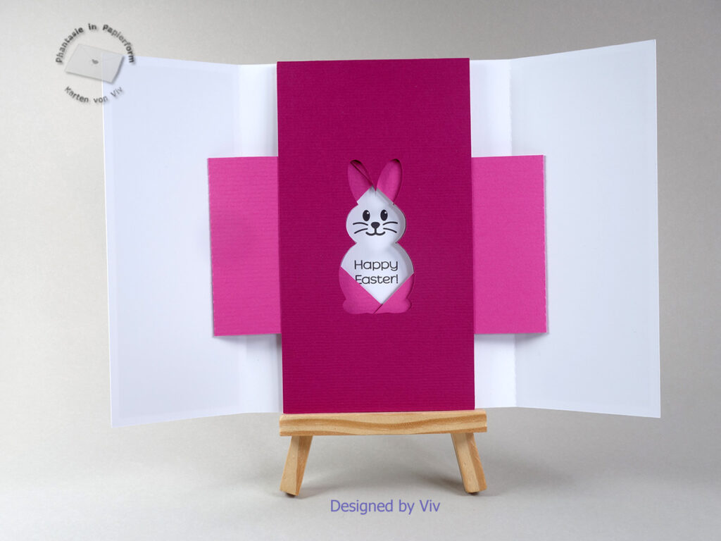 A shutter card is shown open, with a rabbit cut-out shape in the middle through which the words Happy Easter and a rabbit face with big eyes can be seen.