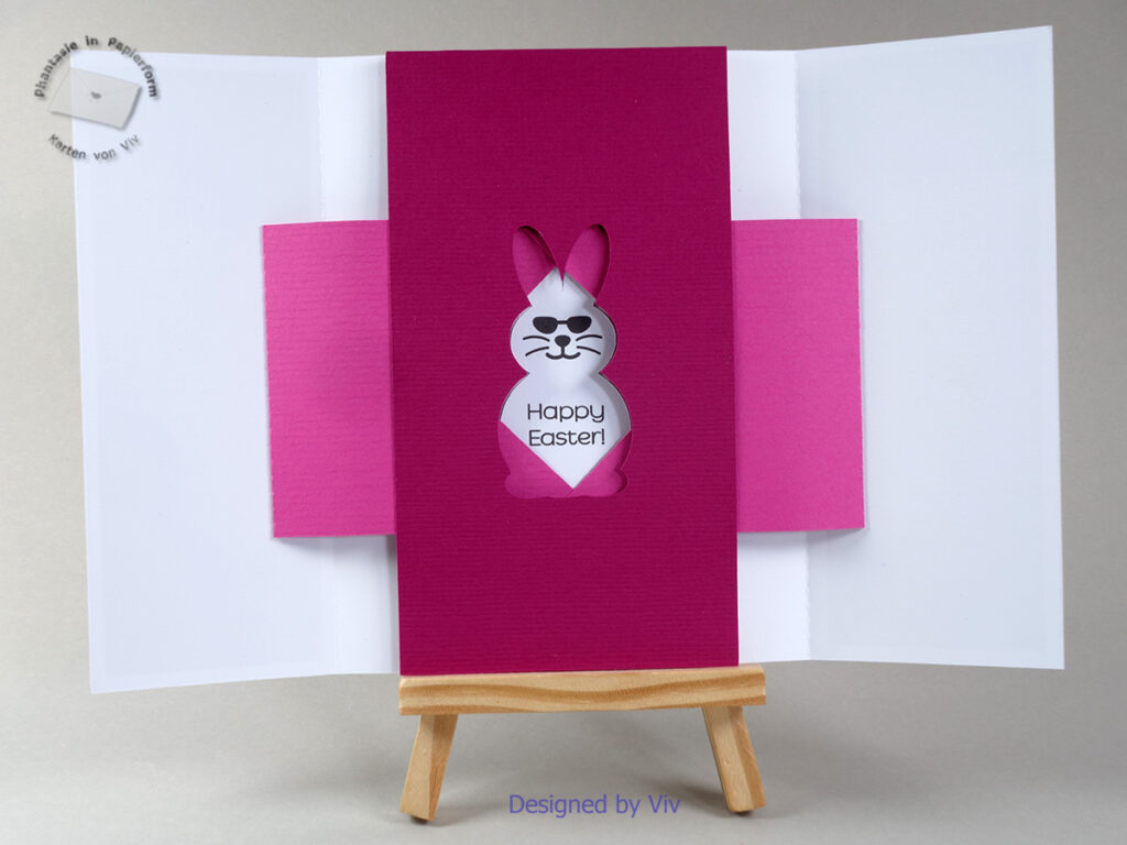 A shutter card is shown open, with a rabbit cut-out shape in the middle through which the words Happy Easter and a rabbit face with sunglasses can be seen.