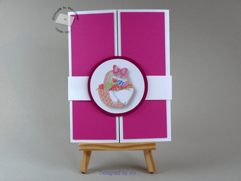 A gatefold card is held closed by a belly band in the centre. The belly band has a circle with a printed easter basket with easter eggs in it.